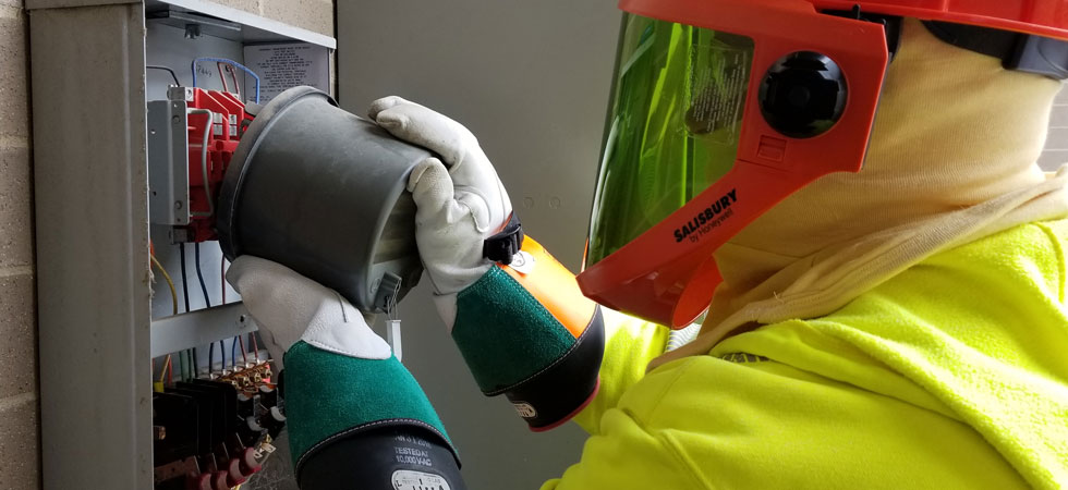 Worker In Personal Protective Equipment Performing Maintenance On An 